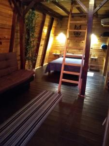 a bedroom with a bed and a ladder in a room at Villas Margarita, Mazamitla, Jalisco. in Mazamitla