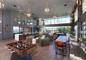 a large room with a table and chairs and a lobby at Pacific Paradise 10 Min from Disneyland With Pool & GYM in Tustin