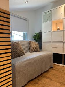 a living room with a couch and a dresser at Mountaindreams, Wallis, near Saas-Fee, SKi, near Mattmark in Saas-Almagell