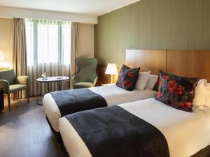 Katil atau katil-katil dalam bilik di Hotel Mercure Porto Gaia