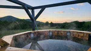 a hot tub on a screened in porch with a view at Zacisze w Karkonoszach in Karpacz