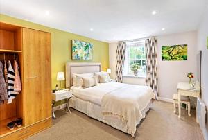 a bedroom with a large white bed and a window at The Old Toffee Works, Montpellier Quarter, Next to Pump Rooms FREE PARKING in Harrogate