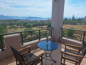a balcony with a table and chairs and a view at The house of joy in Egina +22 photos