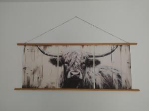 a painting of a bull with horns on a wall at Gîte de la Rouge Roye in Nompatelize +42 photos