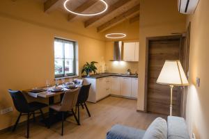a kitchen and dining room with a table and chairs at Villa Sofija in Kojsko