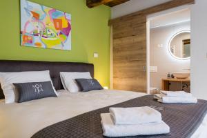 a bedroom with a bed with two towels on it at Villa Sofija in Kojsko +95 photos