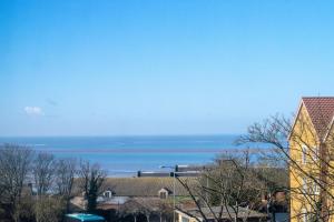 a view of the ocean from a city at Daisy’s - Ellinbrook Apartments in Hunstanton +2 photos