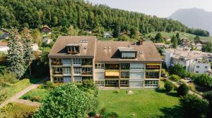 an aerial view of a large house in the mountains at Apartment Baytrail in Seenähe in Spiez