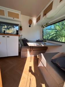 a living room with a table and a couch at Caravane Chic et Vintage in Urrugne