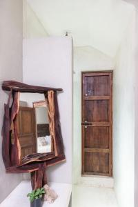 a mirror on a wall next to a door at Casa Mezcalito in San Francisco