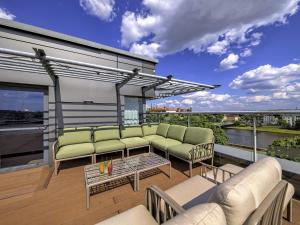 a balcony with couches and a table on a building at Novotel Kraków Centrum in Krakow