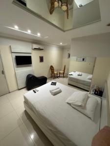 Ένα ή περισσότερα κρεβάτια σε δωμάτιο στο D'lazer Hotel e Motel