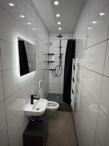 a white bathroom with a sink and a mirror at Ferienwohnung - schönes Heim Li-Apartments in Pforzheim