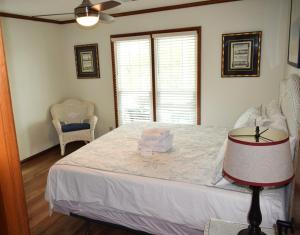 a bedroom with a bed with a hat on it at Keepin It Reel in Holden Beach