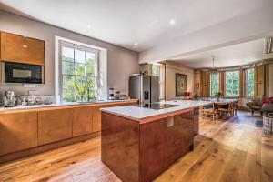 a large kitchen with a large island in the middle at The Old Vicarage in Truro