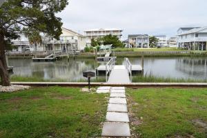 a view of a lake with a dock and houses at Keepin It Reel in Holden Beach