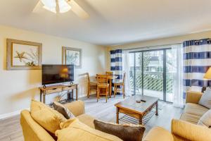 a living room with a couch and a tv at Direct Beach Access! Walkable Condo on Ocean Blvd in Myrtle Beach