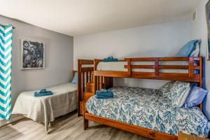 a bedroom with two bunk beds and a bed at Direct Beach Access! Walkable Condo on Ocean Blvd in Myrtle Beach +19 photos