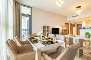 a dining room with a table and chairs at Amazing Rooftop Pool - Full Canal Views - 1 BDR - 5 min walk from Space42 Arena - Heart of Raha Beach in Abu Dhabi