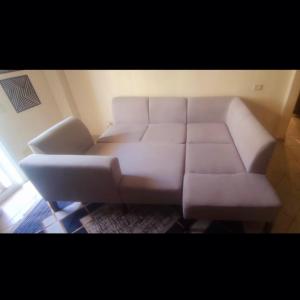 a white couch sitting in a living room at Room self catering in Ossett