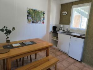 a kitchen with a table and a sink and a table and a table at Appartements indépendants dans chalet en Auvergne in Chomelix