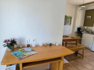 a kitchen with a wooden table with flowers on it at Appartements indépendants dans chalet en Auvergne in Chomelix