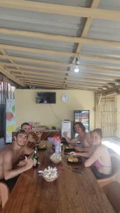 a group of people sitting around a wooden table at Jenny's Bamboo Surf Camp in Karbang +52 photos