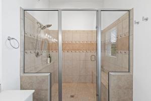 a shower with a glass door in a bathroom at Inn Reel Time in Secession +49 photos