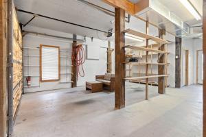 an empty room with wooden beams and a shelf at Inn Reel Time in Secession