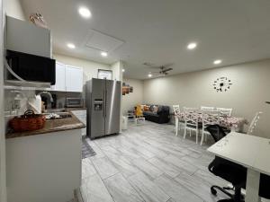 a kitchen and living room with a refrigerator and a table at Sunshine Nest in Lehigh Acres