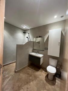 a bathroom with a toilet and a sink at Dar'S in Moulay Douraïne