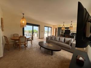 a living room with a couch and a table at Dar'S in Moulay Douraïne