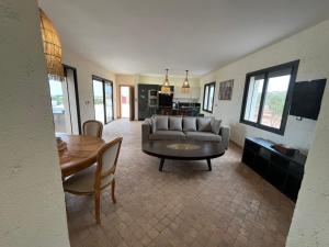 a living room with a couch and a table at Dar'S in Moulay Douraïne +8 photos