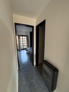 a room with a flat screen tv on a wall at Altos de Maipu in Tandil
