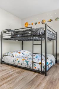 a bedroom with two bunk beds in a room at Niagara Retreat|HotTub|Sauna|Games|15 Min to Falls in Thorold