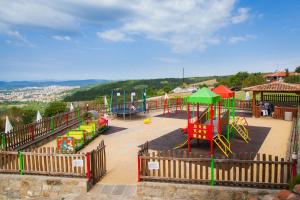 a playground with colorful play equipment in a park at Sevastokrator Relax & Congress in Arbanasi