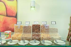 a bunch of different types of food on a table at Hotel Dan Inn Campinas Cambuí - Um Hotel Clássico em Campinas By Nacional Inn in Campinas