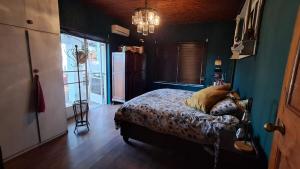 a bedroom with a bed and a chandelier at Kondensmelk in Parys +8 photos