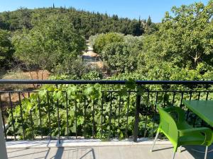 a balcony with a table and chairs and trees at Eva & Resul apartments in Ilias