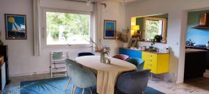 a dining room with a table and chairs at Tamaris, Villa avec très grand jardin in Cucq +19 photos