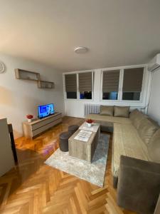 a living room with a couch and a tv at Condo Studio Inn "near Delta Planet" in Niš +12 photos