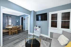 a living room with blue walls and a dining room at Firestone Park Home in Akron