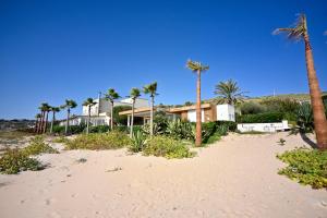 a house on the beach with palm trees at Ristorante Hotel DA VITTORIO in Menfi