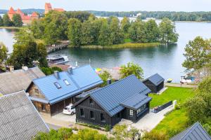 an aerial view of a house on a lake at Lakeview Modern Karaim Cottage Trakai in Trakai