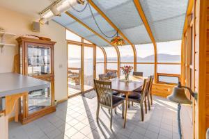a kitchen and dining room with a table and chairs at 9 Mi to Mendenhall Glacier Waterfront Juneau Home in Juneau International Airport