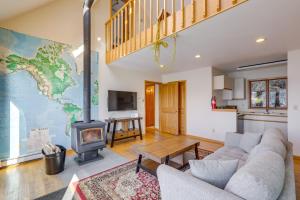 a living room with a couch and a fireplace at 9 Mi to Mendenhall Glacier Waterfront Juneau Home in Juneau International Airport