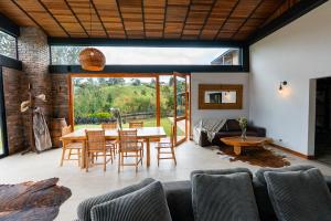 a living room with a table and chairs at Sahara Lodge Nature, Design Arabian Horses in El Retiro