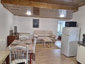 a kitchen and living room with a table and a refrigerator at Casa María in Baltar