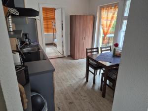 a kitchen and dining room with a table and chairs at Haus am Wendsee in Brandenburg an der Havel +3 photos