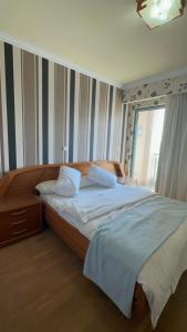 a bedroom with a large bed and a window at Luxury Sea View Apartment in Four Seasons Alexandria in Alexandria